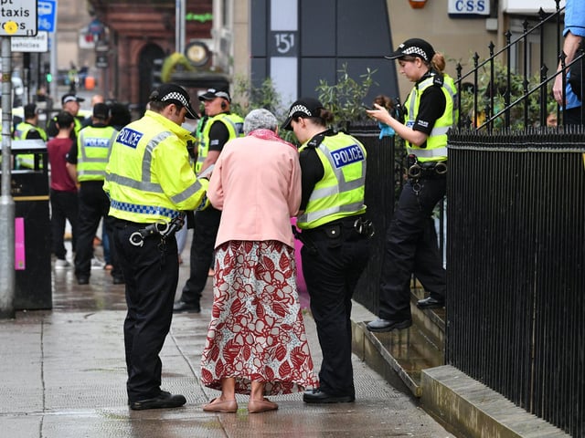 A witness talking to police following a fatal stabbing at an address in West George Street, Glasgow