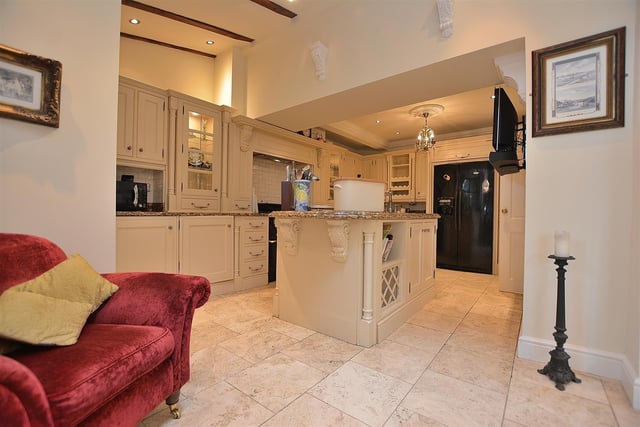 The kitchen also has an island and granite working surfaces.