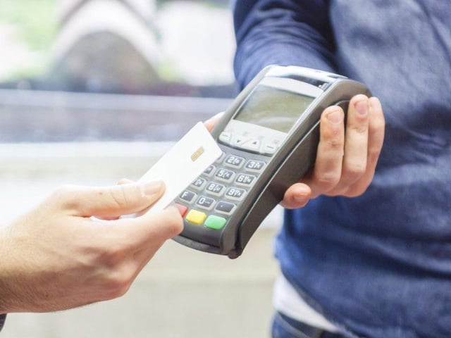 The idea of waving your card at a little screen to pay for your groceries was pure fantasy in 1998. Most people used cash, and, when they did pay with plastic, it involved signing a piece of paper and a store clerk checking it against the signature on the back of your debit card.