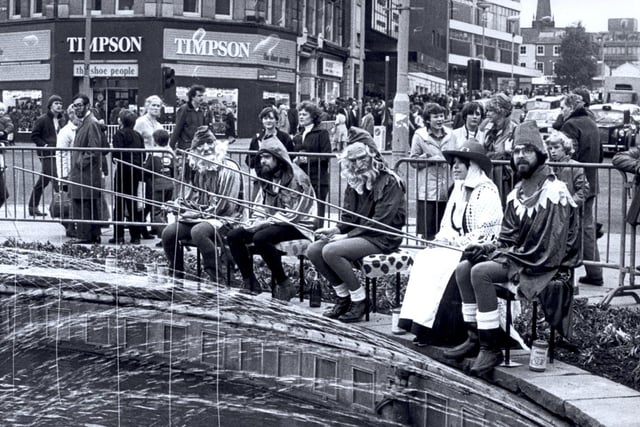 Gnomes fishing in the Goodwin fountain at the top of Fargate as part of the Rag celebrations Oct 28,  1981