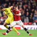 James Garner of Manchester United attempts to tackle Halil Dervisoglu of Brentford (Nathan Stirk/Getty Images)