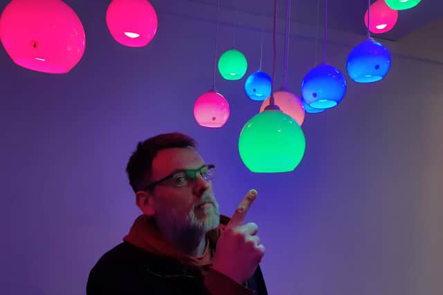 Graham Turnbull has suspended 28 coloured lights in a room above the EE phone shop on The Moor and each one is linked to sensors on buildings across the city.