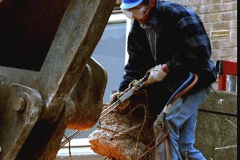 A workman on the site of the demolition of the Oakhill Flats in 1998.