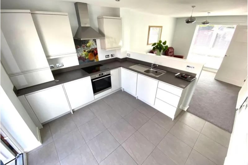 This gorgeous designer kitchen with integrated appliances is open plan to the lounge both of which are illuminated by windows either side with patio doors leading out to the rear patio and garden.
