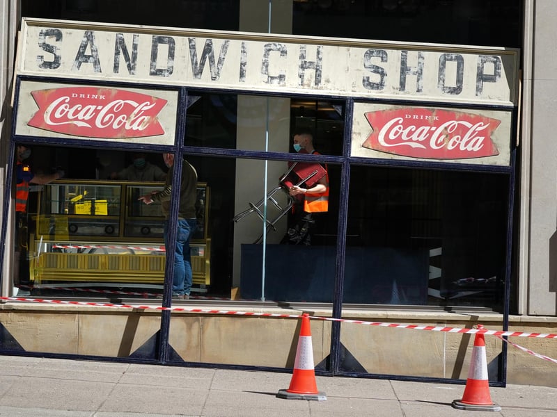Film crew build a fake facade on St Vincent Street in Glasgow.