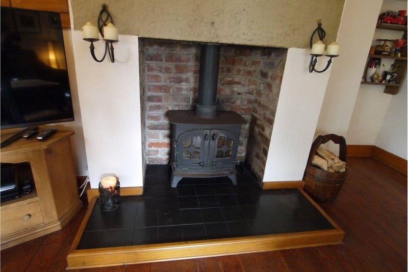 Having a feature wood burning stove with inglenook and hearth,