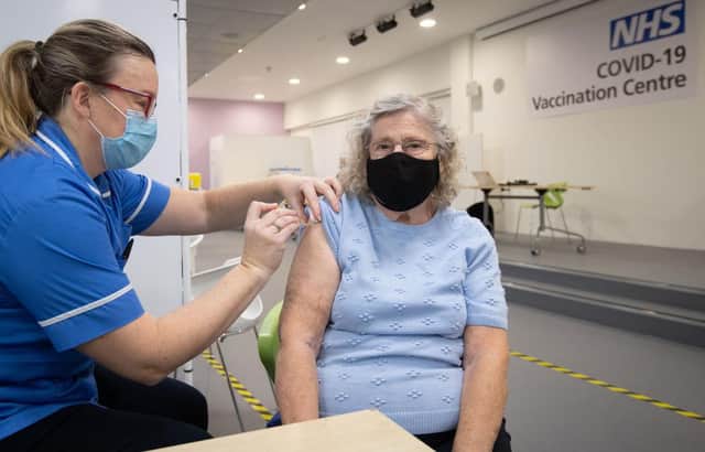 Margaret Austin, 87, on her first time out in six months, receives an injection of a Covid-19 vaccine at a mass vaccination hub (Photo by JOE GIDDENS/POOL/AFP via Getty Images)