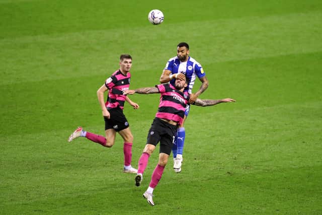 Curtis Tilt of Wigan Athletic competes for a header with Ryan Bowman of Shrewsbury Town during the Sky Bet League One match between Wigan Athletic and Shrewsbury Town at DW Stadium on December 08, 2021 in Wigan, England. (Photo by Lewis Storey/Getty Images)
