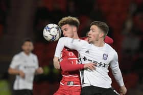 Doncaster Rovers' Josh martin tussles with Ipswich Town's Lee Evans in their League One clash at the Eco Power Stadium last night