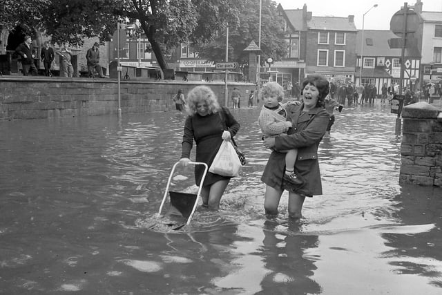 What a great picture! 
Do you recognise anyone wading through the flood water?