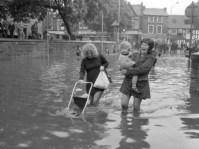 What a great picture! 
Do you recognise anyone wading through the flood water?