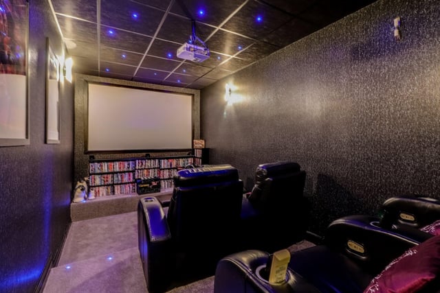 The cosy home cinema benefits from a tiered floor and suspended ceiling, with LED lighting on the floor and roof, with a bose surround sound system.