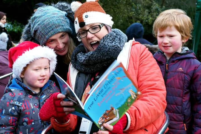 Friends of the Porter Valley Christmas Fair: Kathryn Herold reading her 'Liitle Urban Fox' book to a visiting family