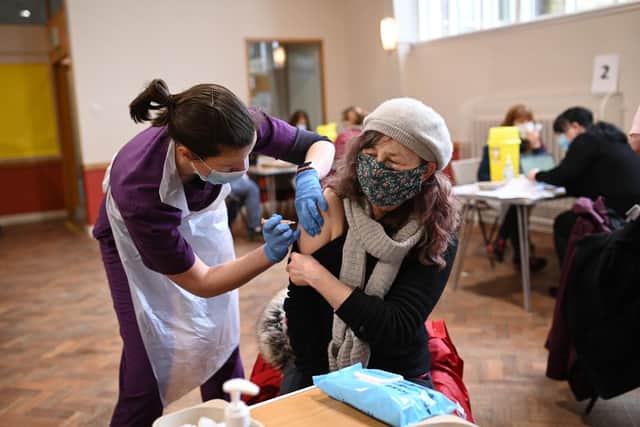 Doctor Kate Martin (L) administers an injection of AstraZeneca/Oxford Covid-19 vaccine to a patient at the vaccination centre set up at St Columba's church in Sheffield (Photo by Oli SCARFF / AFP) (Photo by OLI SCARFF/AFP via Getty Images)