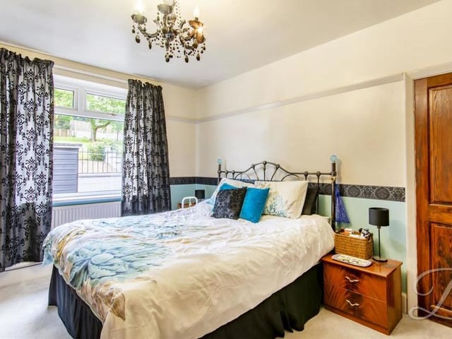 Let's take a look now at the bedrooms, beginning with this one, which has a carpeted floor. The window overlooks the back of the property.