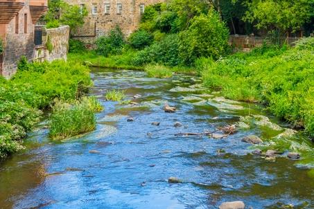 What is this village situated on the Water of Leith called?