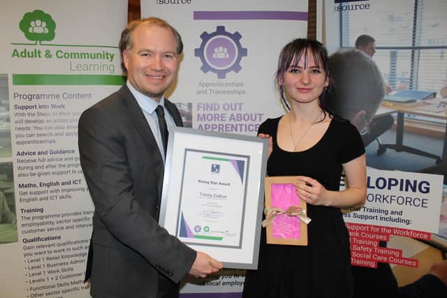 Trinity Dalton receives the Rising Star Apprentice of the Year award from tutor Nathan Bruce
