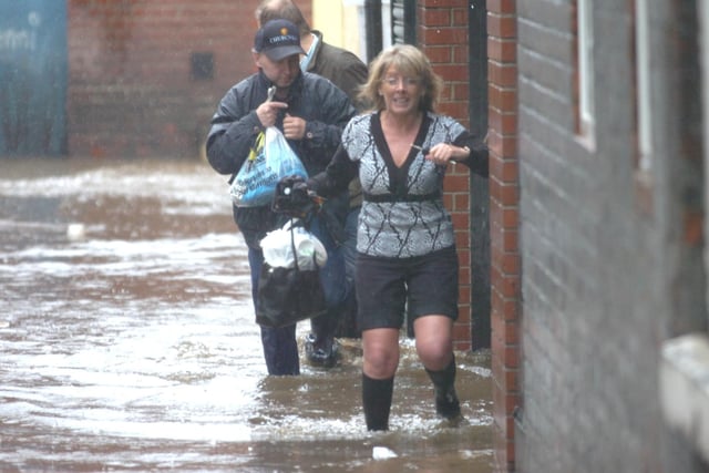 People struggling through the floods at The Wicker on June 26, 2007