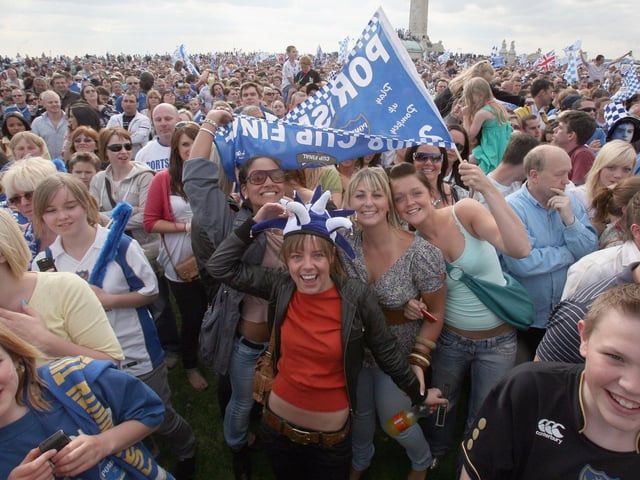 All smiles. Portsmouth fans celebrate as their team arrive in a open top bus as part of their victory parade at Southsea Common following their win in the FA Cup Final 2008 on May 18 2008 in Portsmouth, England. Picture: Matt Cardy/Getty Images