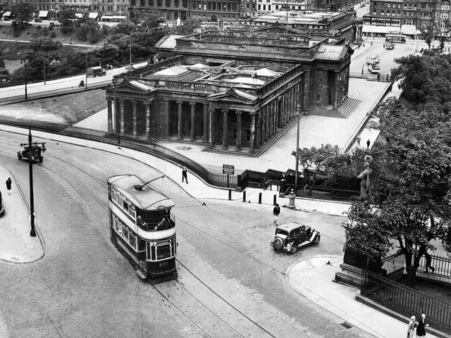 A tram makes its way up the Mound, with snow lying on the ground, in May 1955.