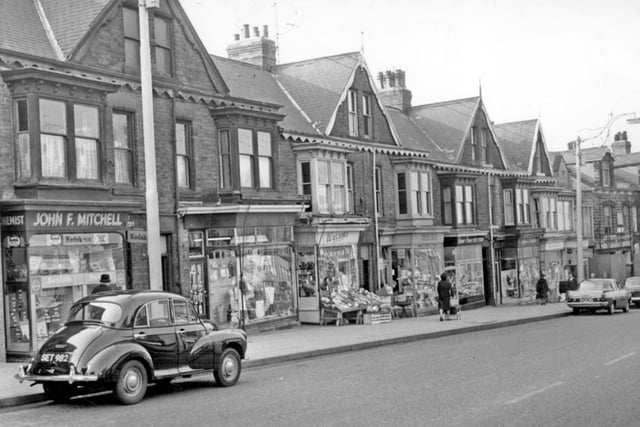 Ecclesall Road, Sheffield, in 1964, showing shops including Jn. F. Mitchell chemists; Mrs Sarah A. Davies drapers, Wilsons fruiterers, and Mrs E.M. Cartwright ironmongers