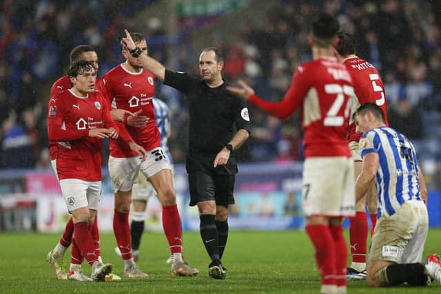 Referee Jeremy Simpson waves away appeals for a late Barnsley goal during the Emirates FA Cup fourth round match at The John Smith's Stadium, Huddersfield.  Barrington Coombs/PA Wire.