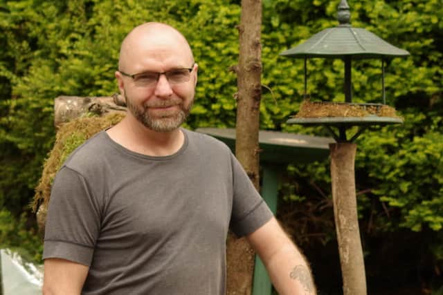 Simon Dell has been told to remove stones placed on grass verges to stop cars churning them into mud