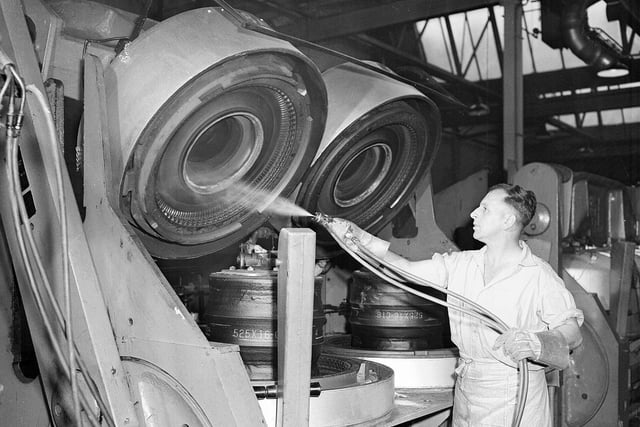 India Tyre and rubber Company Ltd - Factory at Inchinnan - Renfrewshire - M Florence sprays lubricant into  tyre moulds