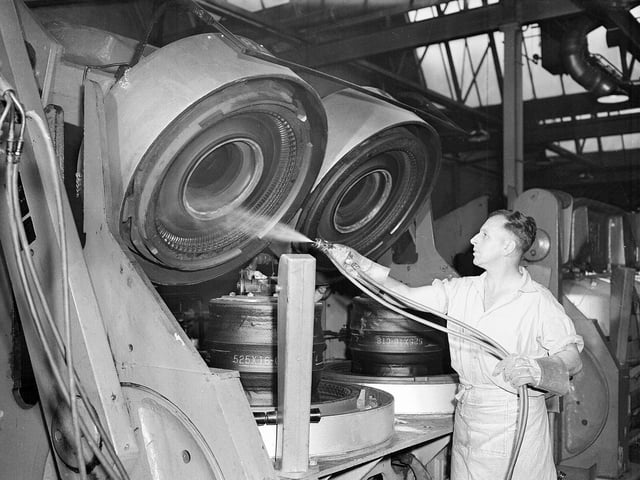 India Tyre and rubber Company Ltd - Factory at Inchinnan - Renfrewshire - M Florence sprays lubricant into tyre moulds