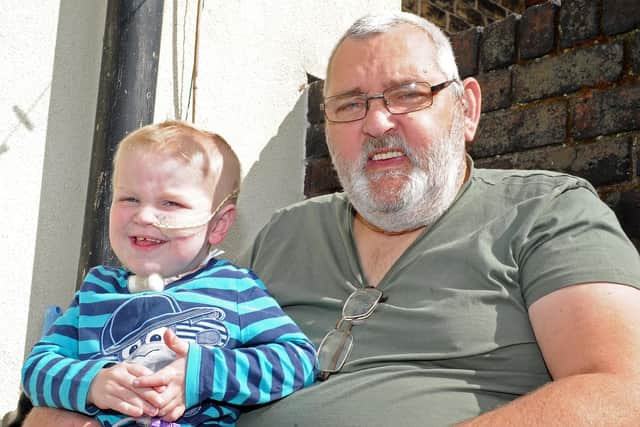 Kevan Adams, pictured with his grandson Jordan Reid at the age of two