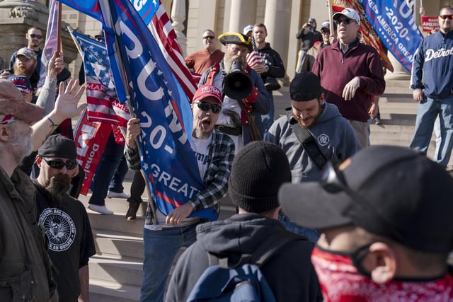 Trump supporters demonstrating the election results are confronted by counter protestors at the State Capitol in Lansing, Mich  (AP Photo/David Goldman)