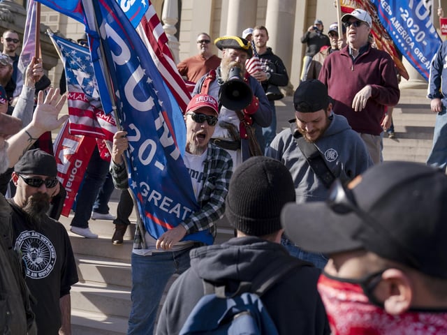 Trump supporters demonstrating the election results are confronted by counter protestors at the State Capitol in Lansing, Mich  (AP Photo/David Goldman)