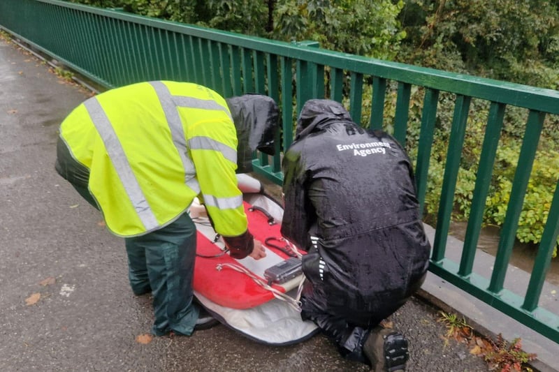 Environment Agency staff on the pedestrian bridge, near Meadowhall,  carry out checks. Picture: David Walsh, National World