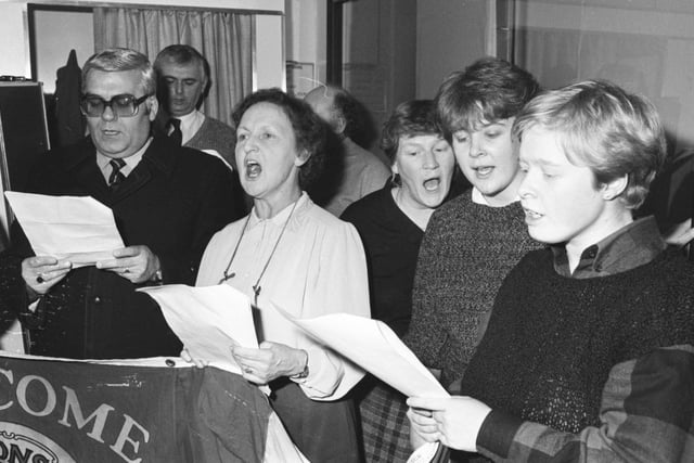 Local singers get in some practice to make sure late Christmas shopping is a cheerful affair. Are you pictured?