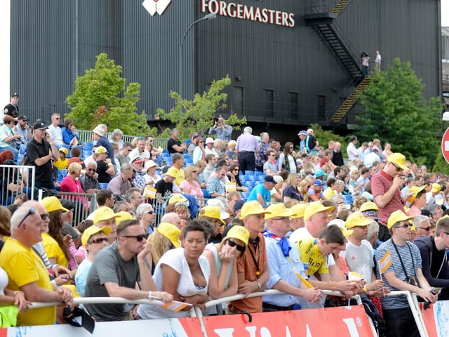 Fans wait at the finish line at Sheffield Arena, in front of Sheffield Forgemasters