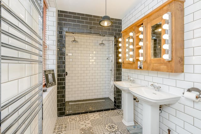 A "stunning en-suite, with his and hers showers, vanity sinks and mirrors".