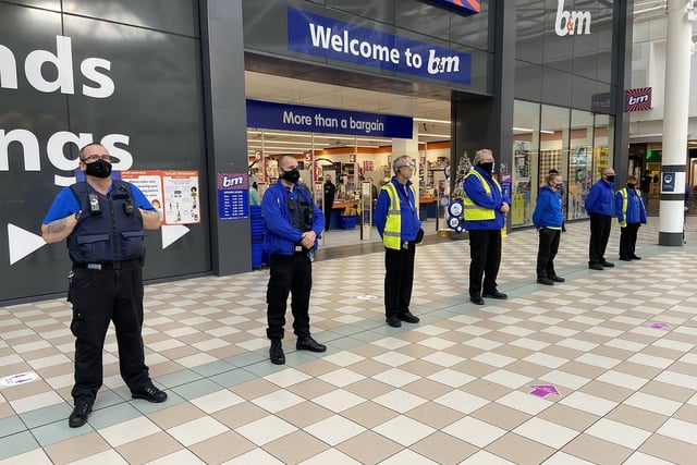 Middleton Grange Shopping Centre staff paused to mark the day in the mall's central square. Picture by FRANK REID