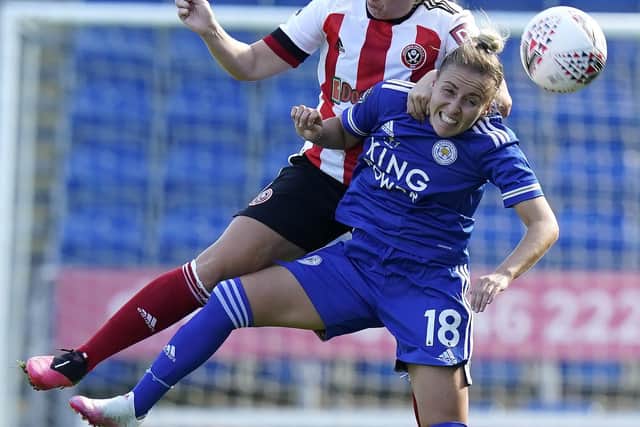 Sheffield United player coach Sophie Walton beats Leicester's Sophie Barker to a header. Photo: Andrew Yates/Sportimage.