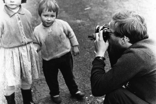 Robert Blomfield pictured taking a portrait of two young girls in Stockbridge.