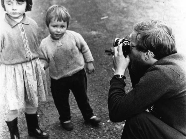 Robert Blomfield pictured taking a portrait of two young girls in Stockbridge.
