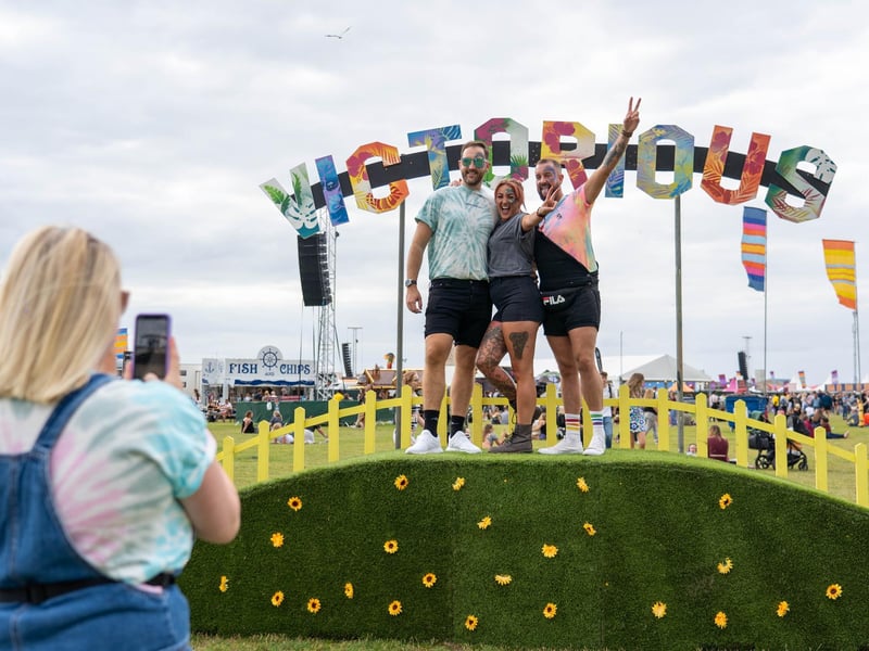 Festival goers pose for pictures at Victorious Festival 2021. Photo by Matthew Clark