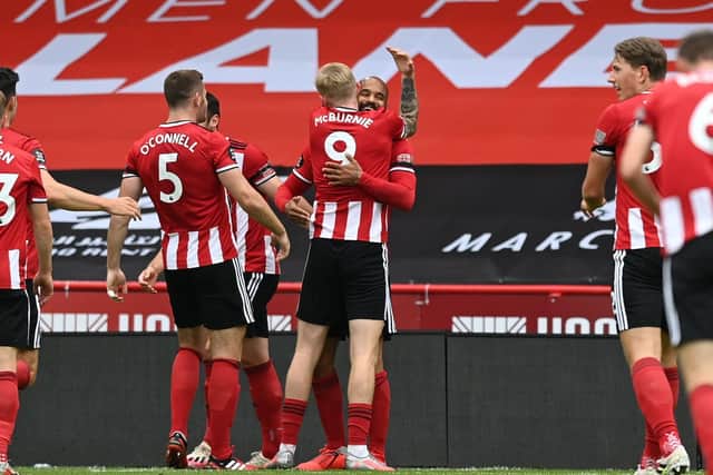 David McGoldrick of Sheffield United celebrates with teammates after scoring his team's first goal during the Premier League match between Sheffield United and Chelsea FC at Bramall Lane. (Photo by Shaun Botterill/Getty Images)