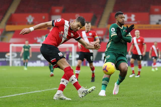 Jan Bednarek of Southampton clears the ball under pressure from Lys Mousset of Sheffield United  during the Premier League match between Southampton and Sheffield United at St Mary's Stadium on December 13, 2020 in Southampton, England: Naomi Baker/Getty Images