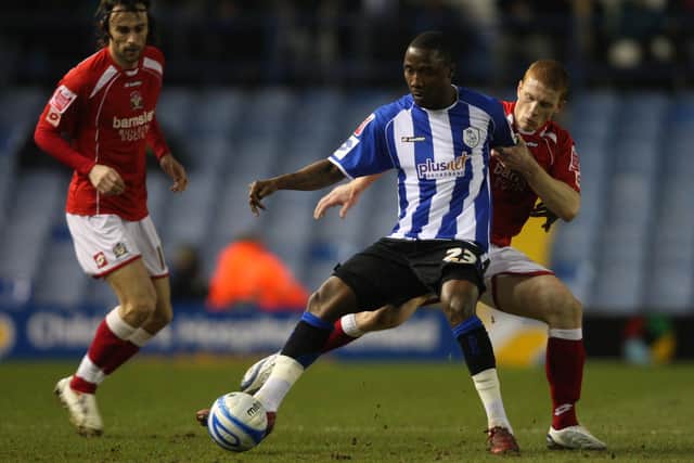 SHEFFIELD, UNITED KINGDOM - FEBRUARY 17:  Jermaine Johnson of Sheffield is challenged by Bobby Hassell of Barnsley during the Coca-Cola Championship match between Sheffield Wednesday and Barnsley at Hillsborough on February 17, 2009 in Sheffield, England.  (Photo by Ross Kinnaird/Getty Images)