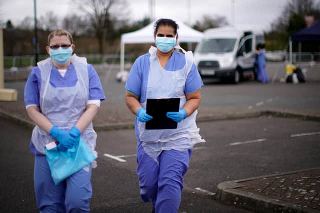 NHS nurses wait for the next patient at a drive through Coronavirus testing site  (Photo by Christopher Furlong/Getty Images)