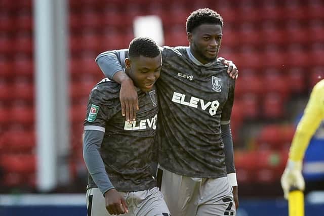 Sheffield Wednesday's Dominic Iorfa puts an arm around new signing Fisayo Dele-Bashiru after his debut at Walsall last week.   Pic Steve Ellis