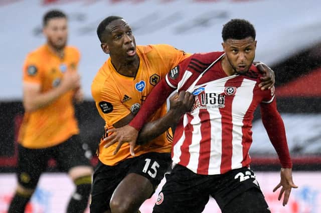 Wolverhampton Wanderers' defender Willy Boly (L) battles with Sheffield United striker Lys Mousset during the English Premier League football match between Sheffield United and Wolverhampton Wanderers at Bramall Lane in July (Photo by PETER POWELL/POOL/AFP via Getty Images)