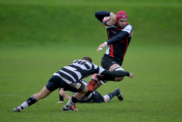 A Chesterfield Panthers player looks to skip a tackle against Belper.