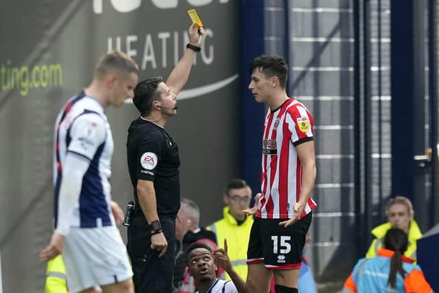 Anel Ahmedhodzic of Sheffield United receives a yellow card from referee Dean Whitestone at West Brom: Andrew Yates / Sportimage
