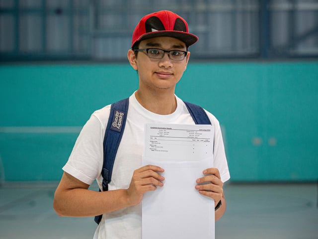 Justin Dizon with his results, A, B and C at UTC College in Portsmouth. Picture: Habibur Rahman